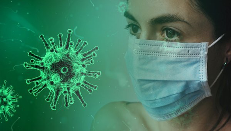 A woman wearing a mask and a microscopic illustration of the coronavirus