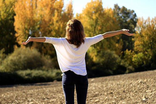 A lady improving her breathing by carrying out deep breath exercise
